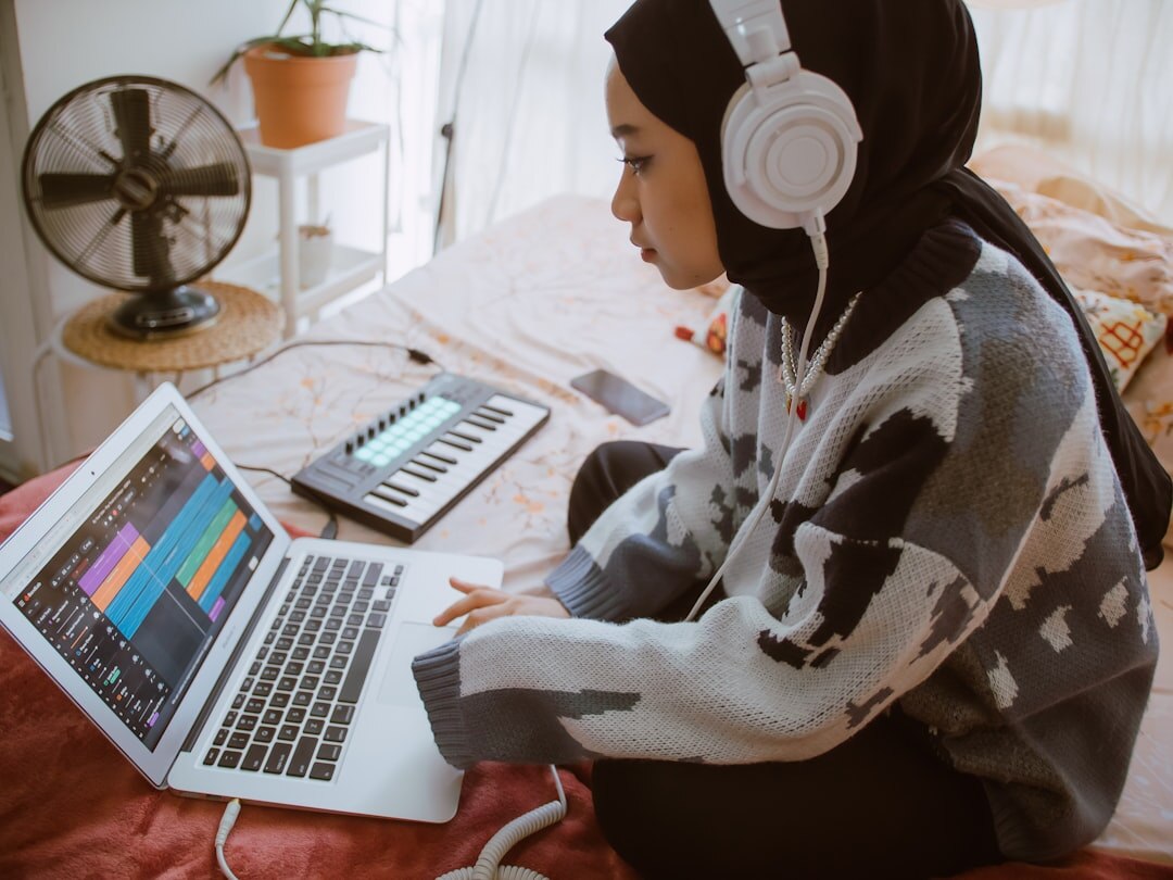 person using laptop with headphones